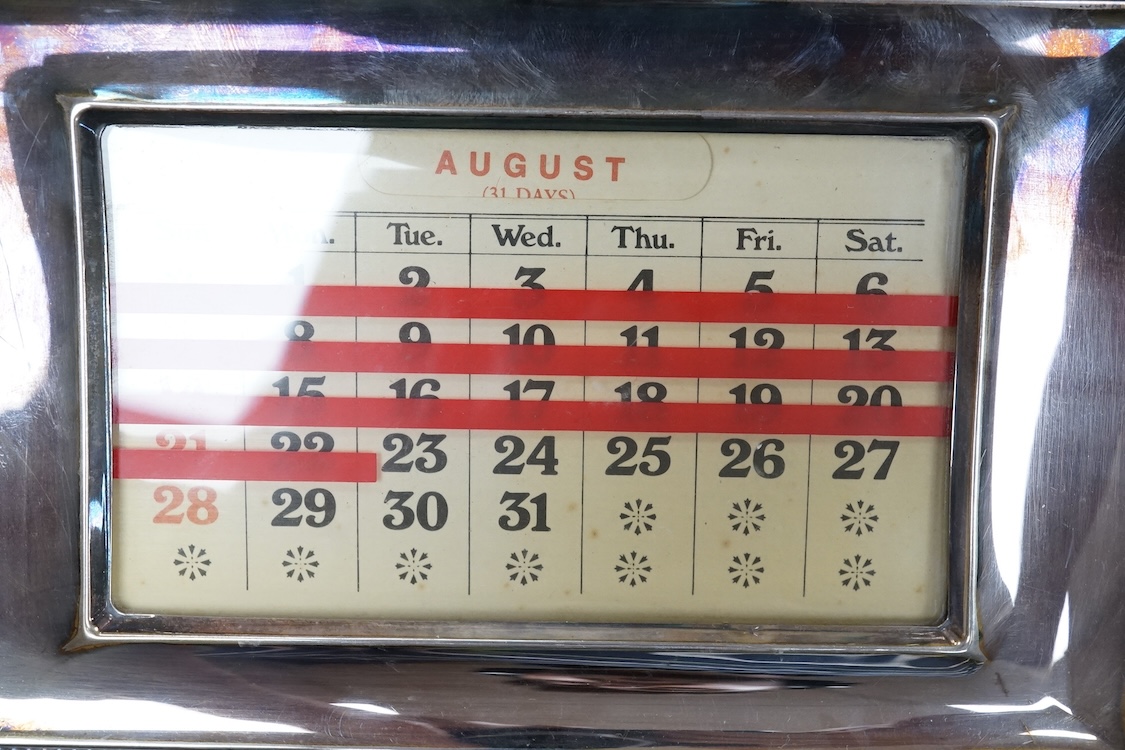 Two modern silver mounted ebonised desk calendars, including one retailed by Asprey, width 21.3cm and a modern silver mounted photograph frame.